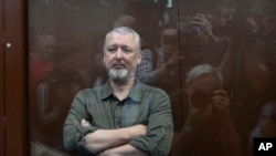 Igor Girkin sits in a glass cage in a courtroom at the Meshchansky District Court in Moscow, July 21, 2023.