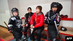 Former North Korean ice hockey player Hwangbo Young coaches an ice hockey class for children at an ice rink in Seoul, April 4, 2017.