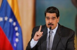 Venezuela's President Nicolas Maduro gestures as he speaks during a news conference in Caracas, Venezuela, Sept. 30, 2019.