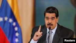 Venezuela's President Nicolas Maduro gestures as he speaks during a news conference in Caracas, Venezuela, Sept. 30, 2019. 