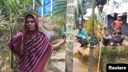 Bangladeshi farmer Jorina Katun stands among the Rohingya Muslims camped out on her land near the Kutapalong refugee camp in the Cox's Bazar district of Bangladesh, Feb. 9, 2018.