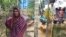 Bangladeshi farmer Jorina Katun stands among the Rohingya Muslims camped out on her land near the Kutapalong refugee camp in the Cox's Bazar district of Bangladesh, Feb. 9, 2018.