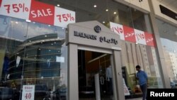 Like many other Saudi retailers, a clothing store in Riyadh offers huge sales to entice consumers. The ripple effect of Saudi Arabia's falling oil prices means its residents have less to spend for the Eid holiday period.