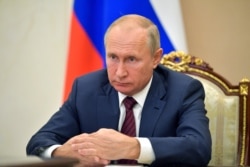 Russian President Vladimir Putin attends a meeting via video conference in Moscow, Nov. 5, 2020.