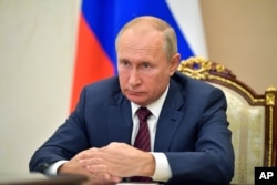 Russian President Vladimir Putin attends a meeting via video conference in Moscow, Nov. 5, 2020.