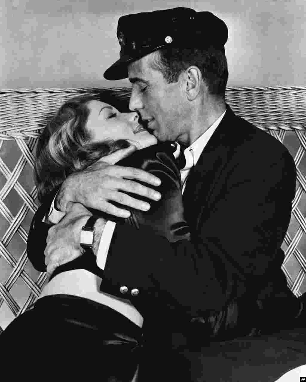 Actor Humphrey Bogart holds actress Lauren Bacall in a tight embrace in their film &quot;To Have and Have Not&quot;, in their first appearance on the screen, January 14, 1957.