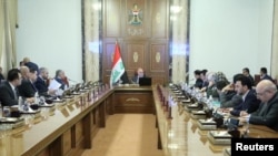 Iraqi Prime Minister Haider al-Abadi attends a meeting with officials in Baghdad, Iraq, Aug. 28, 2018. 