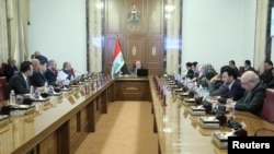 Iraqi Prime Minister Haider al-Abadi attends a meeting with officials in Baghdad, Iraq, Aug. 28, 2018. 