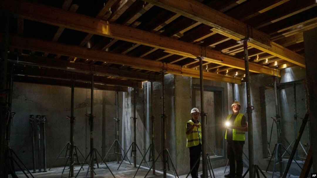 FILE - Builders inspect the construction of an underground version of School No. 88 in Zaporizhzhia, Ukraine, Aug. 30, 2024.