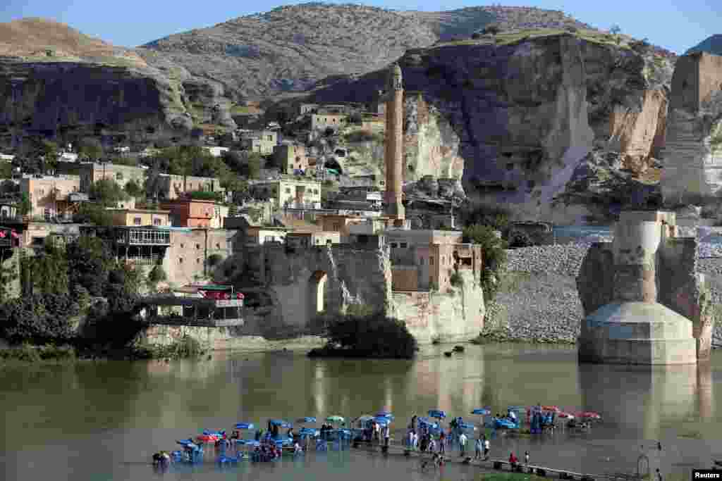 A general view of the ancient town of ÊHasankeyf by the Tigris river, which is significantly submerged by the Ilisu dam being constructed, in southeastern Turkey, Aug. 26, 2018.