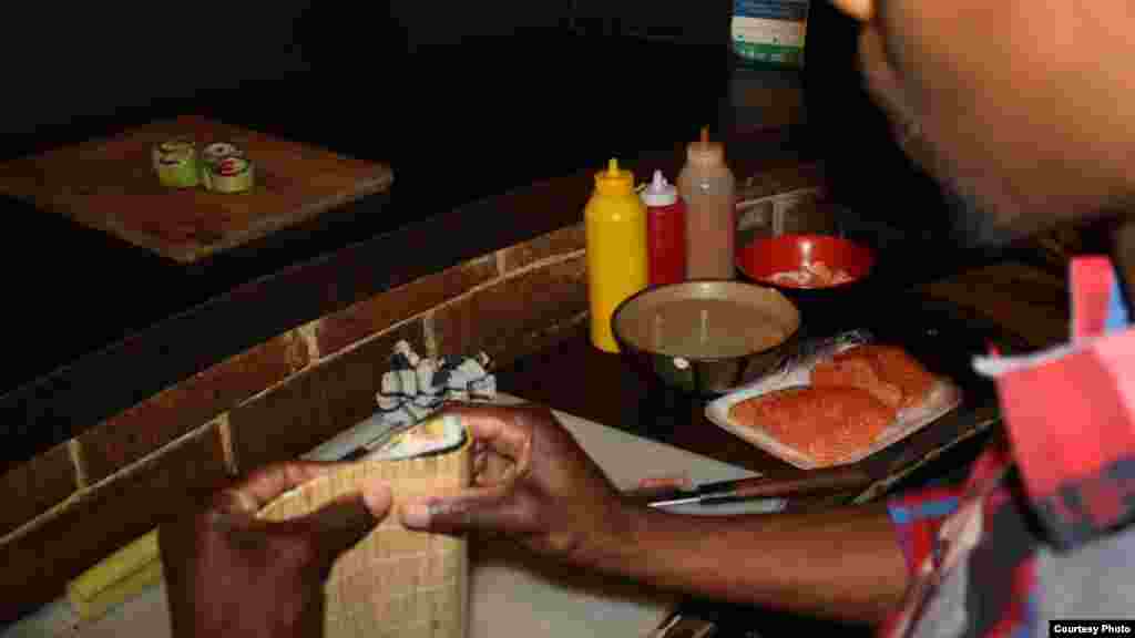 Khumalo sculpts a tasty mouthful of sushi for a hungry customer. (Photo by Darren Taylor)