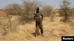 FILE - A Nigerien soldier takes a position during Flintlock 2014, a U.S.-led international training mission for African militaries, in Diffa, March 6, 2014.