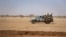 FILE - Burkina Faso soldiers patrol atop a pick-up truck on the road between Dori and Goudebo, in Burkina Faso, Feb. 3, 2020. 