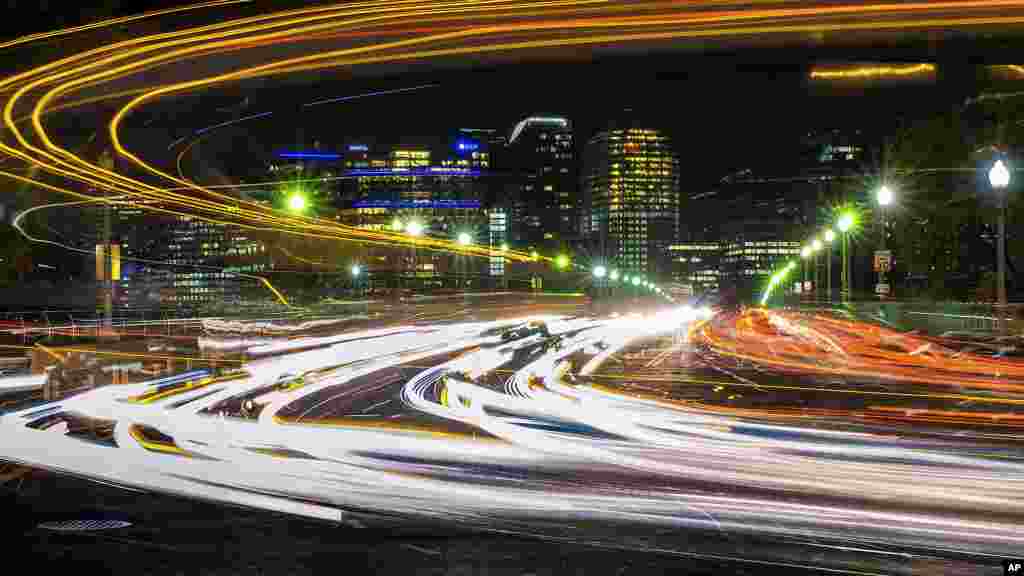 Traffic streaks across the Francis Scott Key Bridge linking Virginia and Washington at the start of the Thanksgiving holiday weekend, Nov. 22, 2017, in Washington.