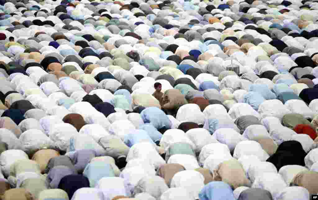 Pakistani faithful offer Eid al-Fitr prayers to celebrate the end of the holy month of Ramadan in Peshawar, Pakistan.