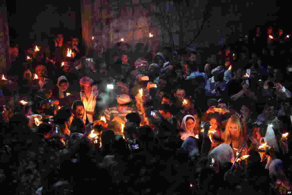 Yazidis gather to celebrate the New Year, their first since Islamic State militants swept through the area last summer, while some capture the event with their mobile phones at the holy shrine of Lalish, 57 kilometers (35 miles) north of militant-held Mosul, Iraq.