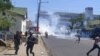 Protesters run from tear gas in Blantyre, Malawi, Nov. 19, 2021. (Lameck Masina/VOA)