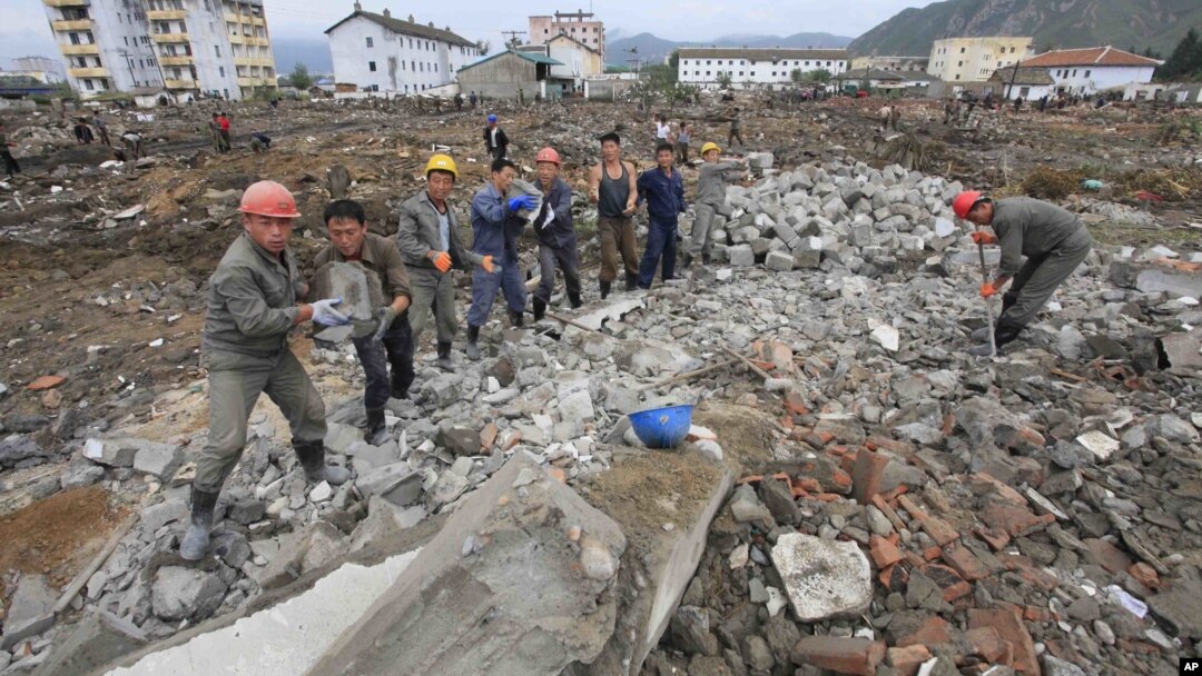 FILE - Workers recover cement blocks from flood-damaged areas in Onsong, North Hamgyong Province, North Korea, Sept. 16, 2016. Amid recent nuclear tensions, Pyongyang is struggling to secure aid for victims of flooding that occurred earlier this month.