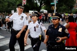 NYPD officers keep an eye on protesters as they take part in a protest against the killings of Alton Sterling and Philando Castile during a march in New York July 7, 2016. (Reuters)