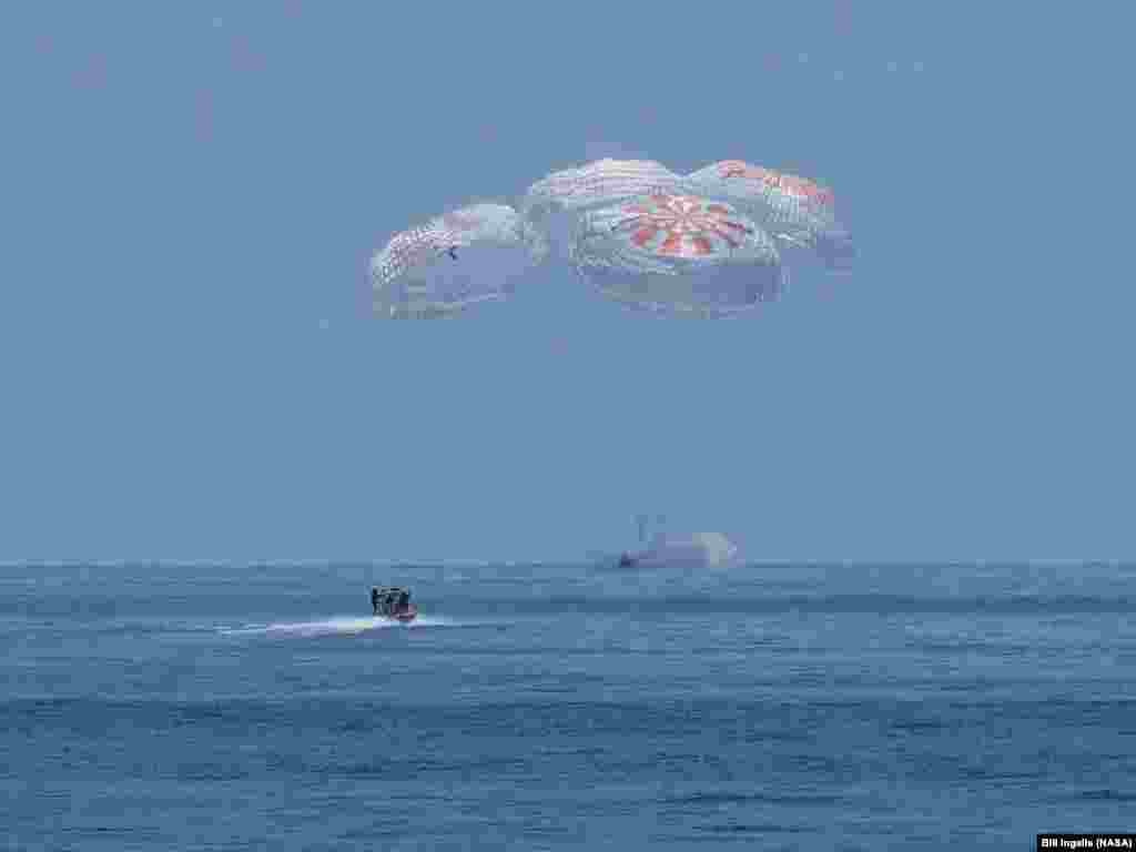 The SpaceX Crew Dragon Endeavour spacecraft is seen as it lands with NASA astronauts Robert Behnken and Douglas Hurley on board in the Gulf of Mexico off the coast of Pensacola, Florida, Aug. 2, 2020.