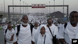 Muslim pilgrims arrive to cast stones at a pillar symbolizing the stoning of Satan, in a ritual called Jamarat, the last rite of the annual Hajj, on the first day of Eid al-Adha, in Mina near the holy city of Mecca, Saudi Arabia, Sept. 12, 2016.
