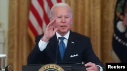 U.S. President Joe Biden responds to questions from reporters as he meets with his Competition Council in the East Room of the White House in Washington, Jan. 24, 2022.