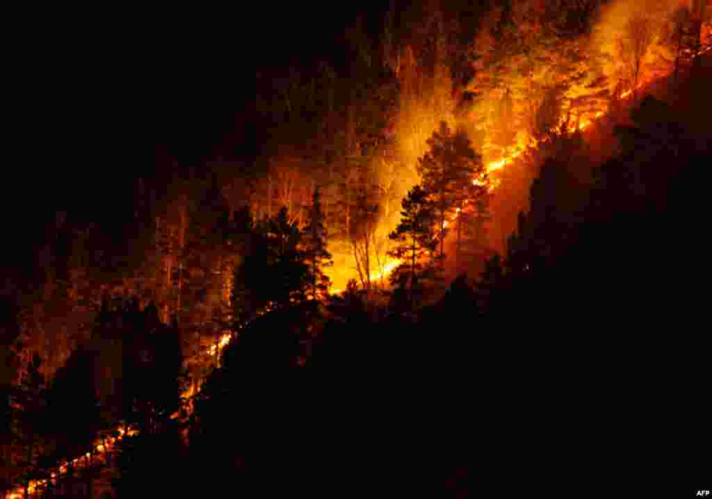 April 21: Dry grass, bushes and trees burn on the bank of the Yenisei River in Taiga district near Russia's Siberian city of Krasnoyarsk. (Reuters/Ilya Naymushin)