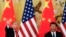 FILE - U.S. President Donald Trump waves next to Chinese President Xi Jinping after attending a joint press conference at the Great Hall of the People in Beijing.