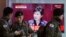 South Korean army soldiers pass by a TV screen showing the live broadcast of South Korean President Park Geun-hye's speech, at the Seoul Railway Station in Seoul, South Korea, Tuesday, Feb. 16, 2016.