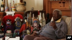 FILE - South African photographer Peter Magubane, speaks with The Associated Press during an interview at his home, in Johannesburg, June 2, 2016. 