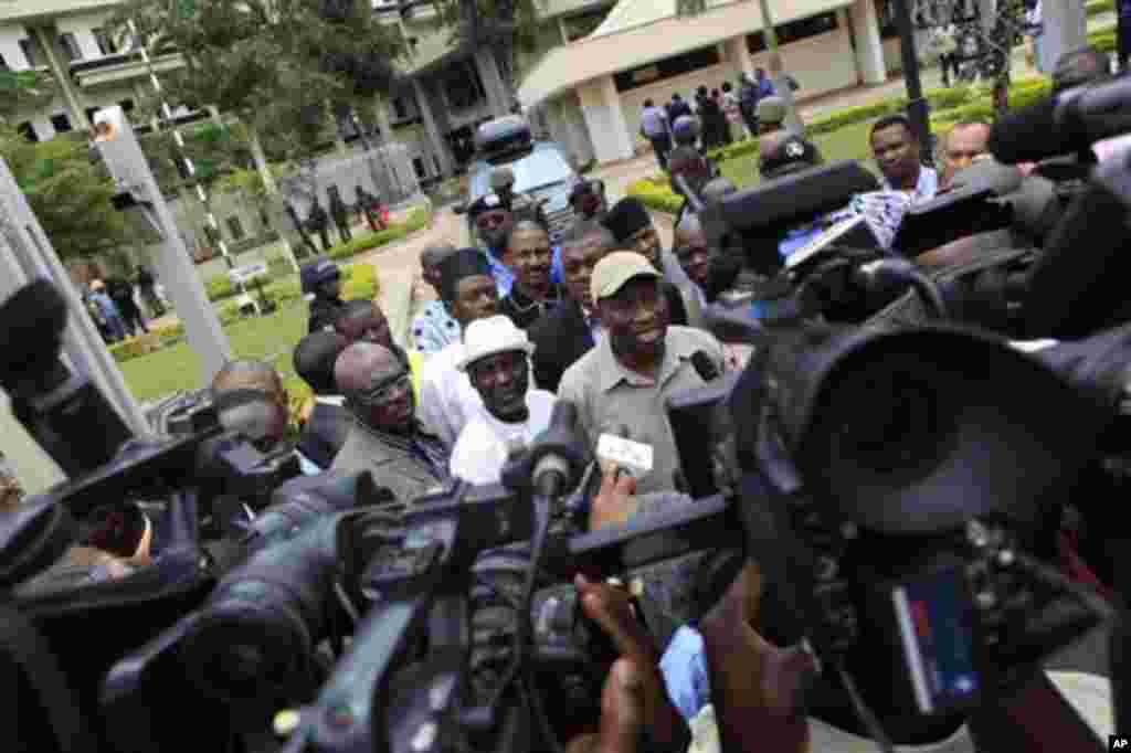 Nigeria's president Goodluck Jonathan, center right, fields questions from journalists as he leaves U.N. headquarters, where a day earlier a suicide bomber crashed through an exit gate and detonated a car full of explosives, in Abuja, Nigeria Saturday.