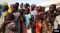 People rescued from the Sambisa forest line up to receive donated clothes in Malkohi, Nigeria, May 5, 2015. (VOA / Chris Stein)