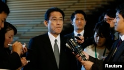 FILE - Japan's Foreign Minister Fumio Kishida listens to questions from reporters at Prime Minister Shinzo Abe's official residence in Tokyo.