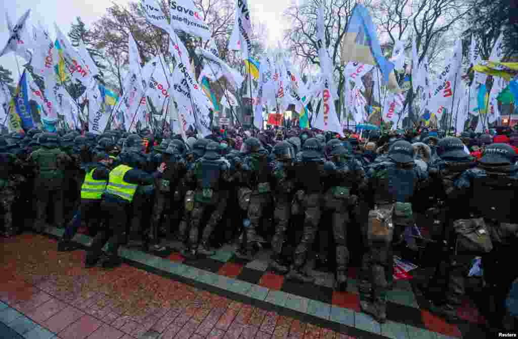 Ukrainian law enforcement officers block demonstrators during a rally held by business people and representatives of small businesses near the parliament building amid the COVID-19 outbreak in Kyiv.
