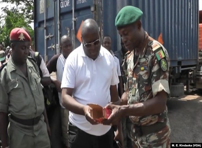 Military officials examine ammunition.