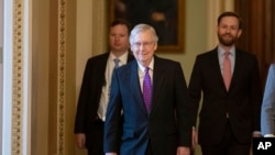 Senate Republican Majority Leader Mitch McConnell, center, leaves the Senate Chamber on Capitol Hill, in Washington, Feb. 4, 2020.