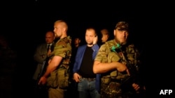 Ukraine -- Self-proclaimed Prime Minister of the pro-Russian separatist "Donetsk People's Republic" Aleksandr Borodai (C)