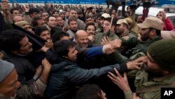 Activists of the Awami Ittihad party get into a scuffle with Indian policemen as they are stopped during a protest to mark International Human Rights Day in Srinagar, India, Dec. 10, 2015. 