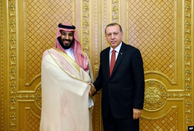 FILE - Turkey's President Recep Tayyip Erdogan, right, shakes hands with Saudi Crown Prince Mohammed bin Salman in Jiddah, Saudi Arabia, July 23, 2017.