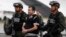 FILE - Daniel Barrera is escorted to a waiting car, prior to his extradition to the U.S, at the counternarcotics base in Bogota, Colombia, July 9, 2013. 