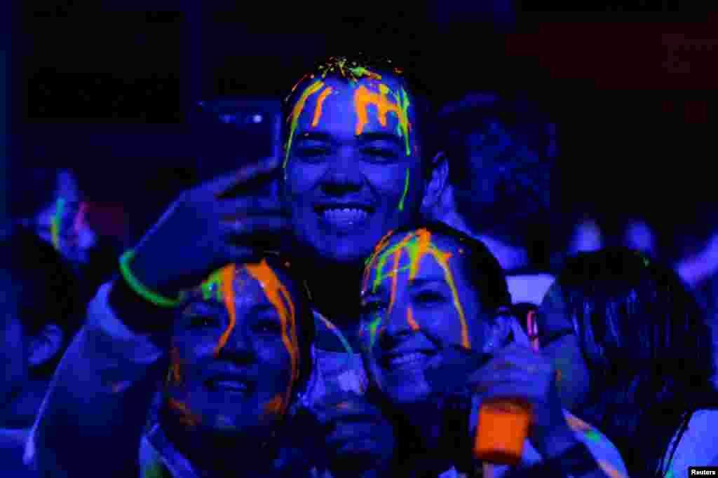 Participants take a selfie after a nocturnal 5K color glow party run in Monterrey, Mexico, Nov. 19, 2016.