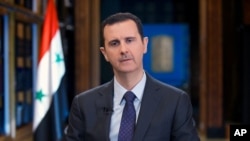 FILE - Syrian President Bashar Assad speaks during a television interview.