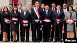 Peru's President Martin Vizcarra, center, and new ministers pose for a picture during their swearing-in ceremony at the government palace in Lima, Peru, April 2, 2018. 