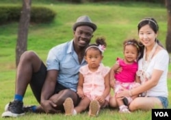 Lily Lee, a Korean, with daughters, Yuri (left) and Dasomi (right), and husband, James, a Nigerian.