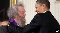 FILE - President Barack Obama presents a 2010 National Medal of Arts to poet Donald Hall, during in a ceremony in the East Room of the White House in Washington, March 2, 2011. 