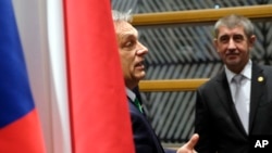 Hungarian Prime Minister Viktor Orban, left, speaks with Czech Republic's Prime Minister Andrej Babis during a meeting of the Visegrad Group on the sidelines of an EU summit in Brussels, Dec. 14, 2017. 