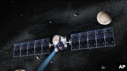 Artist's concept of NASA's Dawn spacecraft. The giant asteroid Vesta, Dawn's current destination, is on the lower left. Another larger asteroid and Dawn's second destination, Ceres, is on the upper right
