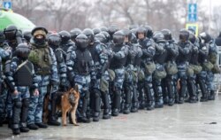 Law enforcement officers stand guard during a rally in support of jailed Russian opposition leader Alexei Navalny in Moscow, Russia, Jan. 23, 2021.