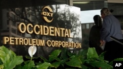 FILE - An employee enters the Occidental Petroleum headquarters in Los Angeles, Jan. 29, 2010. 