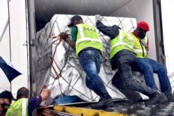 Workers load South Africa's first COVID-19 vaccine shipments as they arrive at OR Tambo airport in Johannesburg, Feb. 1, 2021. (Credit: Elmond Jiyane for GCIS/Handout)